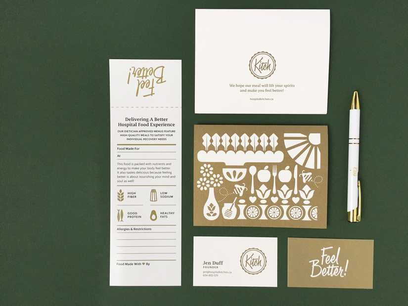 Stationery set laid out on a dark green background with postcard, food bag label, business card and pen.